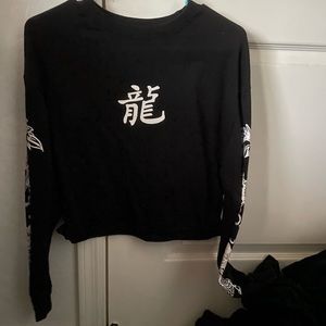 Black crop top, the character says dragon!